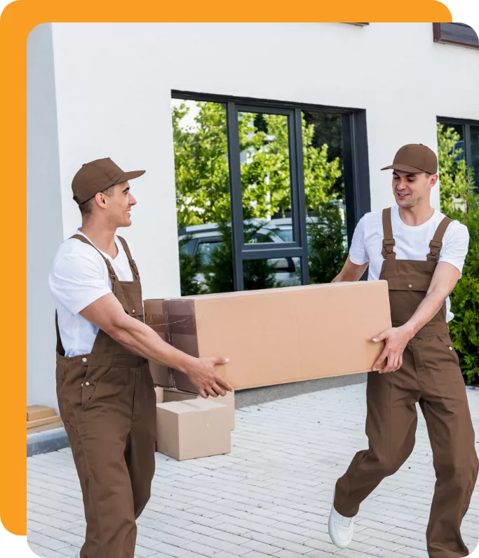 Movers carrying a big cardboard box