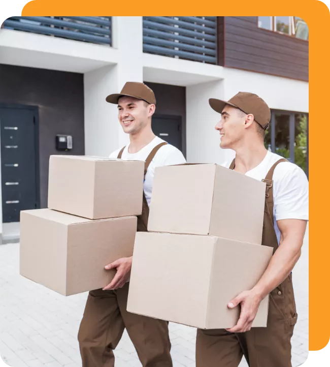 Movers carrying stacked cardboard boxes
