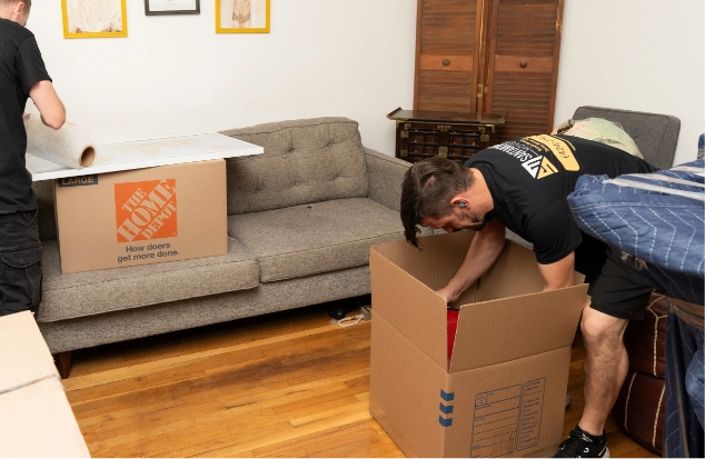 Movers putting items in boxes