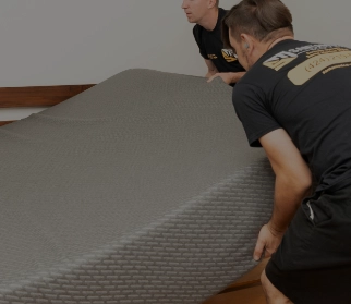 Movers holding a packed household item
